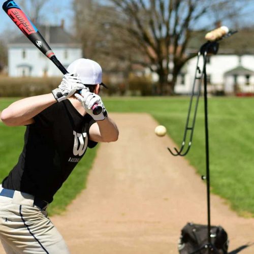 louisville slugger soft toss pitching machine batting tee with player in action